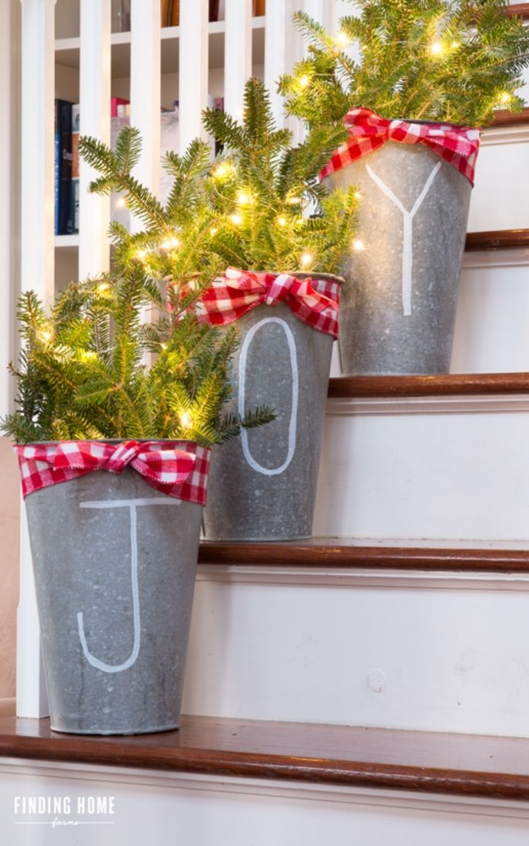 Galvanized Joy buckets with lights and greenery