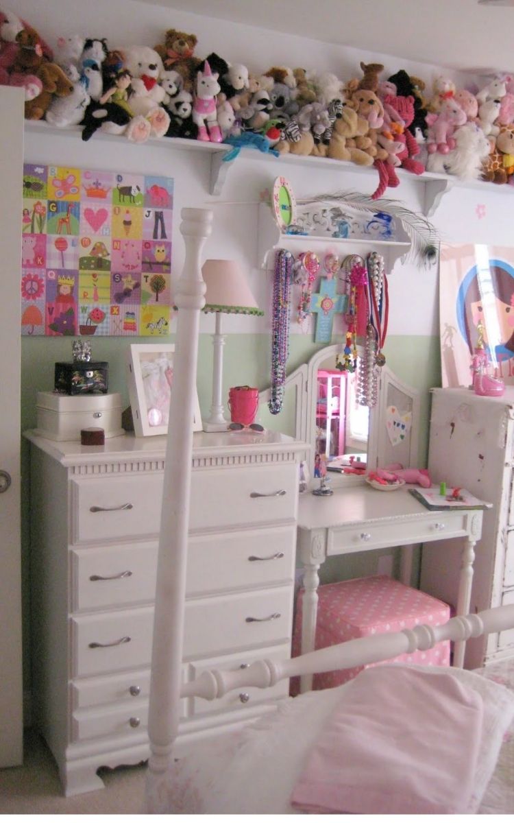 stuff animals displayed on a high shelf