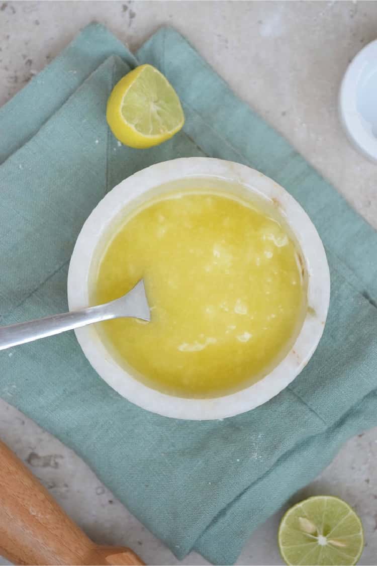 Make your own leather cleaner - recipe done - mixed in a white bowl with a fork in the mixture