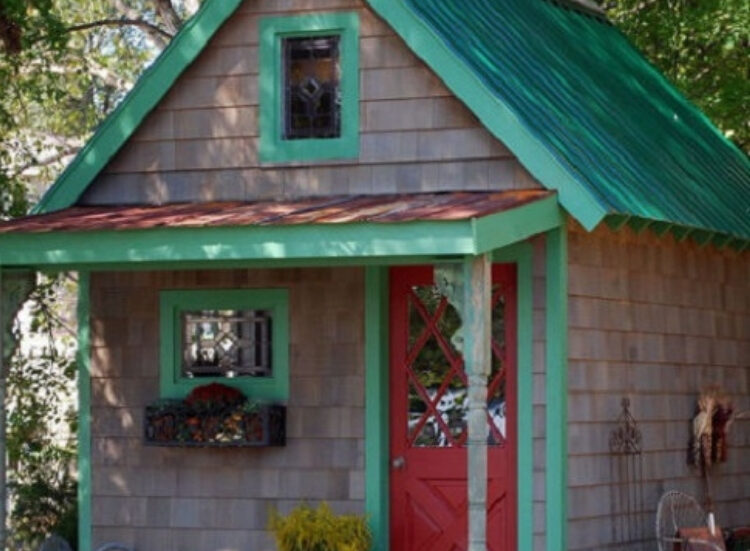 Old shed transformed into backyard center piece with fresh paint and flowers