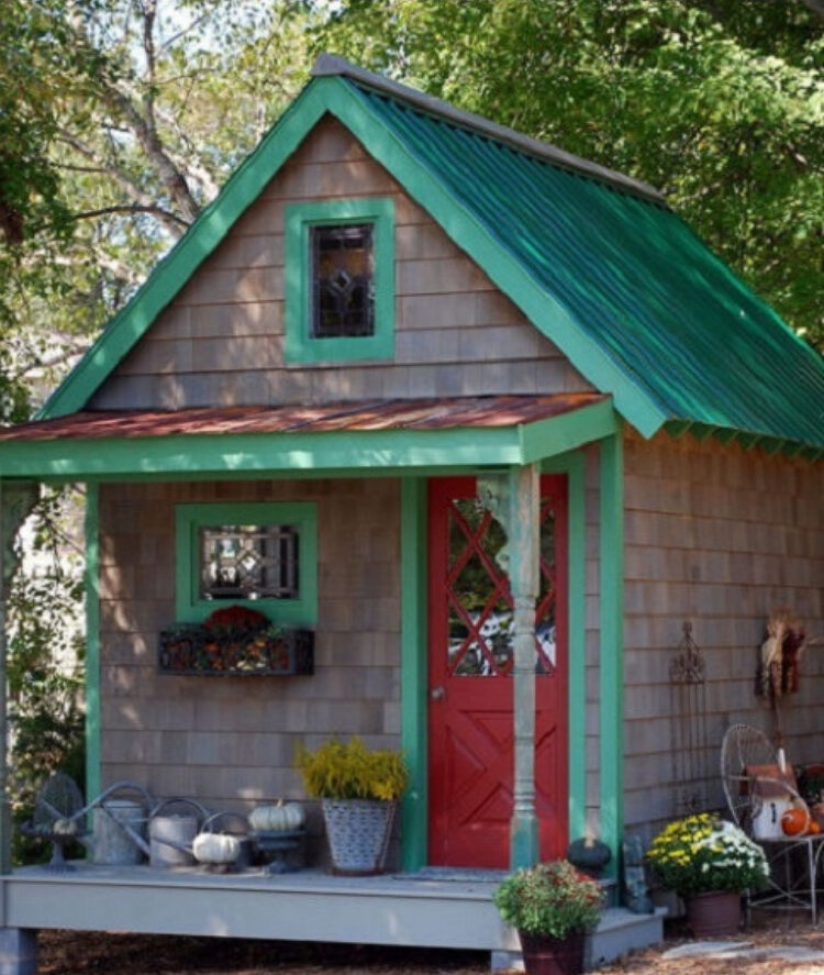 Old shed transformed into backyard center piece with fresh paint and flowers