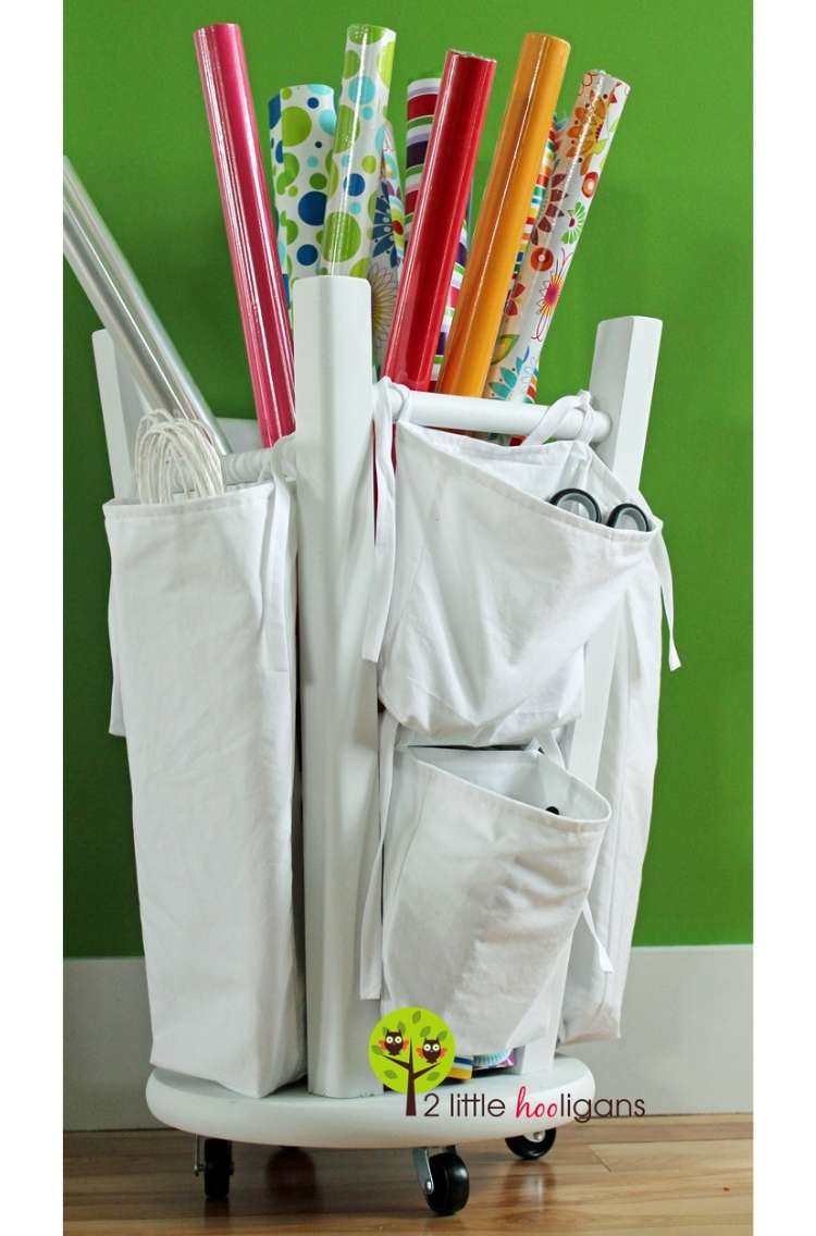 OneCrazyHouse DIY Home Organization giftwrap tubes being stored in upsidedown stool with storage area attached to the legs of the stool