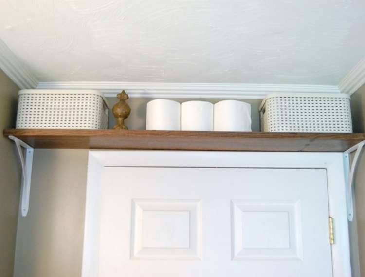 OneCrazyHouse DIY Home Organization shelf installed right above bathroom doorframe for storage