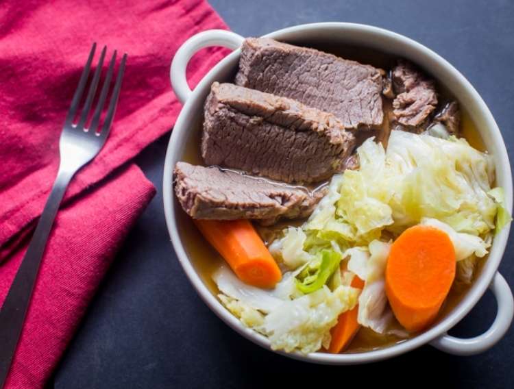 One Crazy House Instant Pot Dinners Corned beef and cabbage in a pot with a fork and napkin next to it