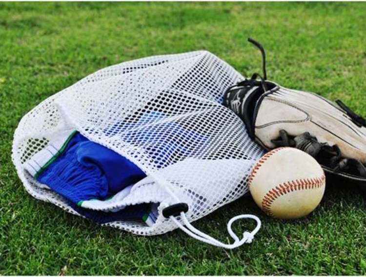 OneCrazyHouse Mesh Laundry Bags mesh laundry bag on grass filled with sports equiptments with a baseball and a glove laying beside the bag