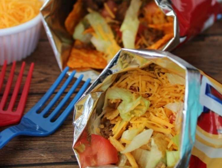 OneCrazyHouse Party Food ideas 2 individual bags of tortilla chips with taco ingredients inside and plastic forks