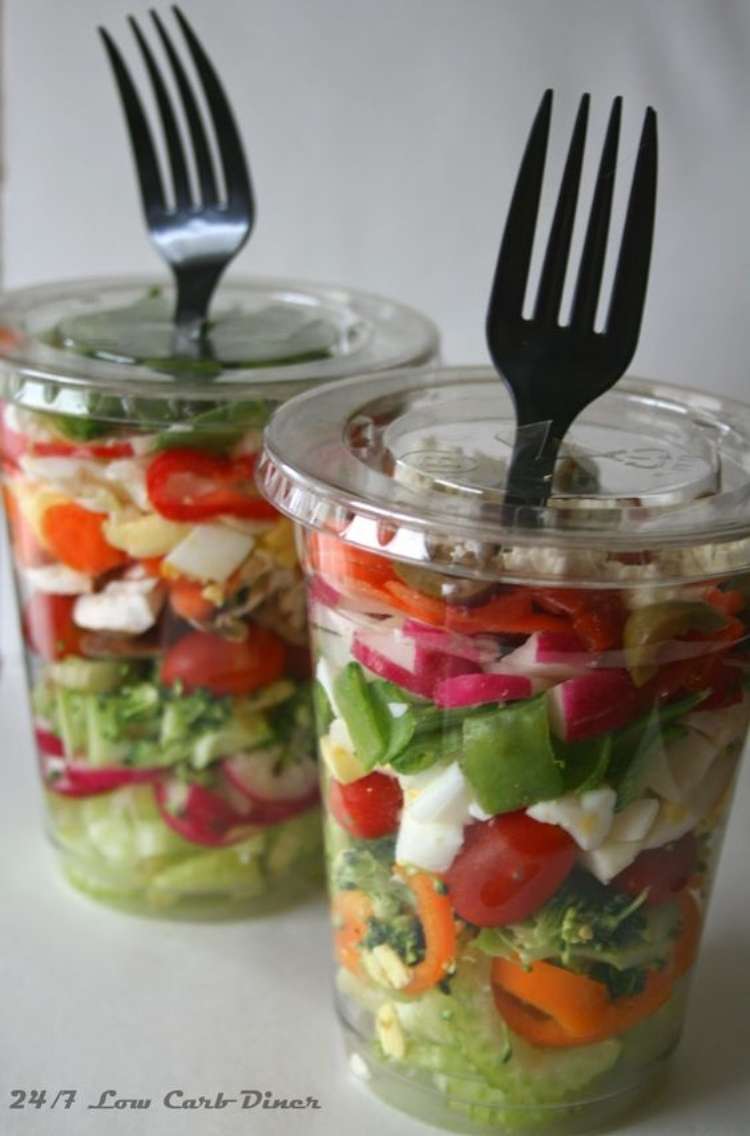 OneCrazyHouse Party Foods two plastic cups filled with salad ingredients with a fork coming out of the straw hole.