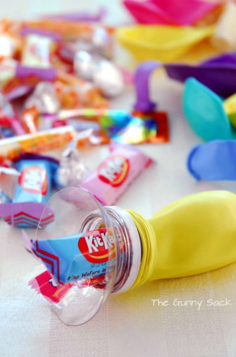 OneCrazyHou se Party Foods Candies being stuffed into balloons with top of plastic bottle around balloon opening