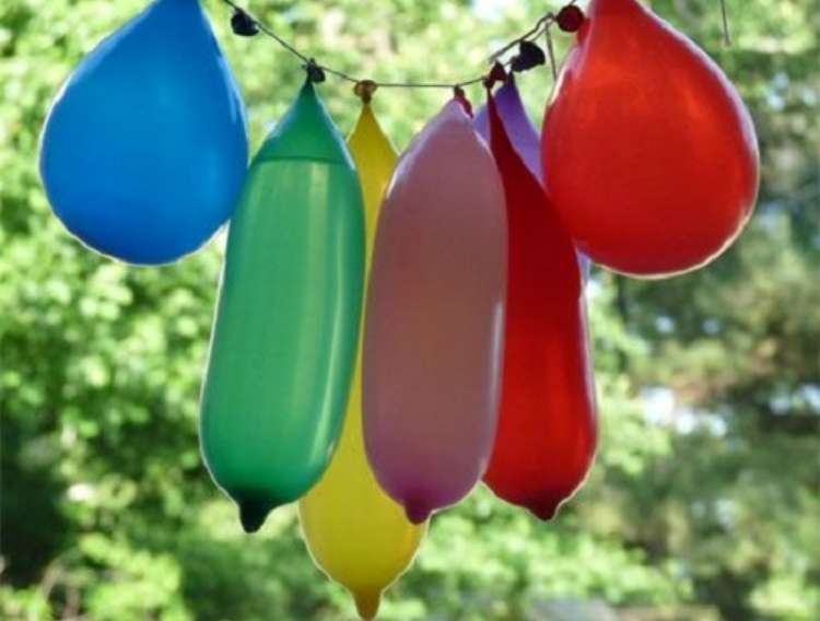 OneCrazyHouse Stay Cool without a pool water filled balloons hanging from a sting with leaves in the background