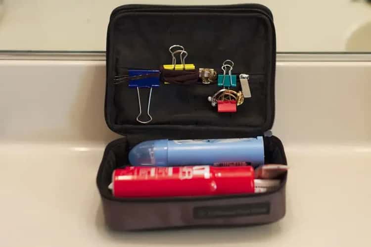 Organize your travel accessories inside the bag using file binder clips