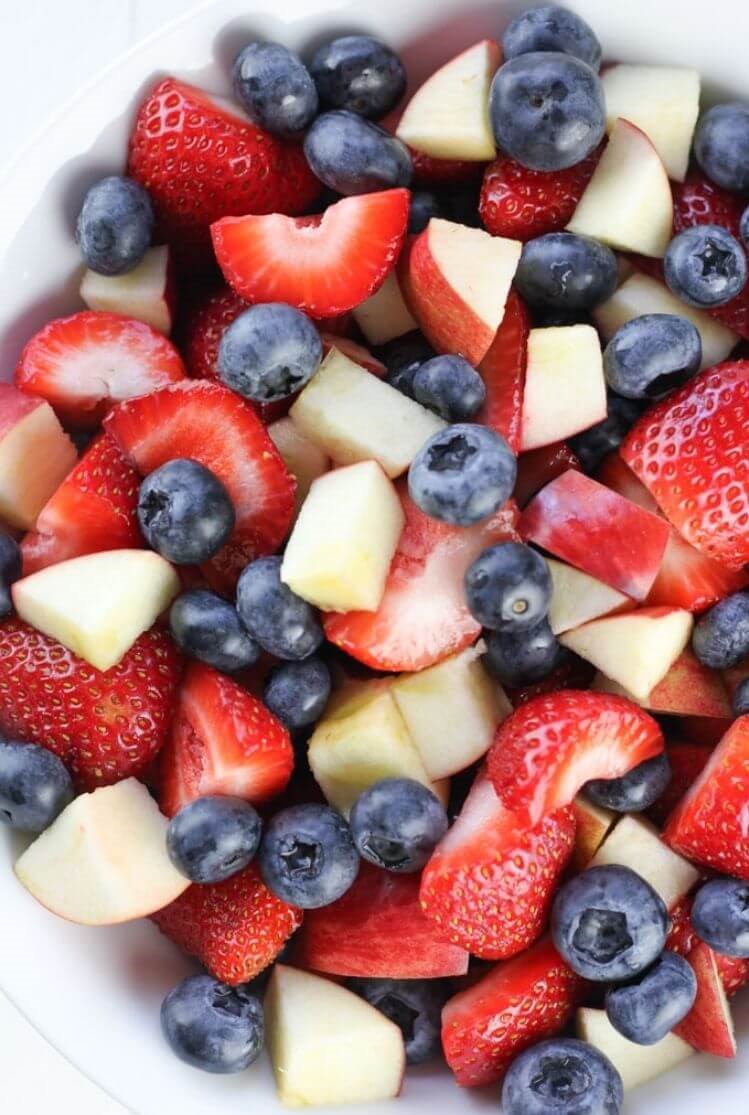 4th of July food idea - red, white, and blue fruit salad using strawberries, apples, and blueberries