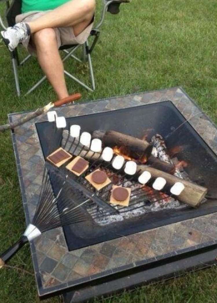 genius cookout hacks- smores being cooked on a clean garden rake 