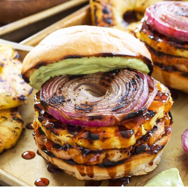 Teriyaki turkey burger, topped with grilled red onions and an avocado sauce.