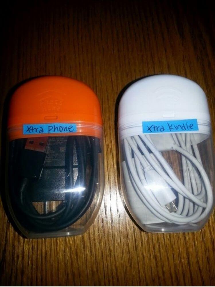 Empty Tic-Tac containers with cords stored inside and labeled with the type of cord it is holding