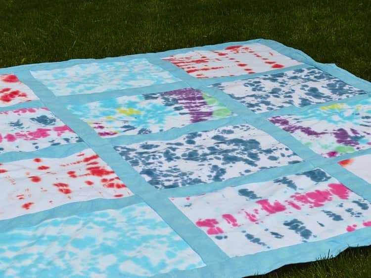 picnic blanket made from a patchwork of old tie-and-dye t-shirts