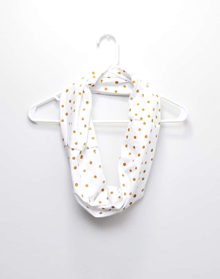 white polka dot infinity scarf on a hanger 