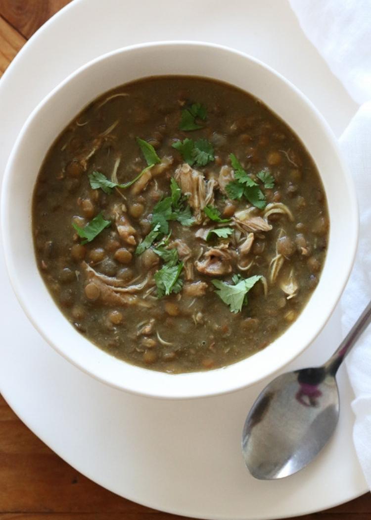 Healthy Hearty Chicken and Lentil Soup - Delicious looking hearty chicken and lentil soup in a white bowl, on a large plate with spoon and napkin.