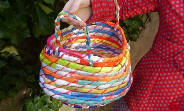 plastic bags rolled up to create a colorful plastic bag basket making a great packing hack