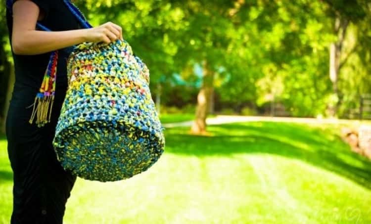 A large watertight crochet plastic bag made from recycled plastic bags. A brilliant packing hack for beach days! 