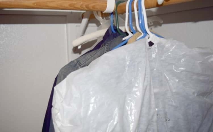 Genius packing hack: out-of-season clothes stored in a plastic bag to protect them while they are out of use