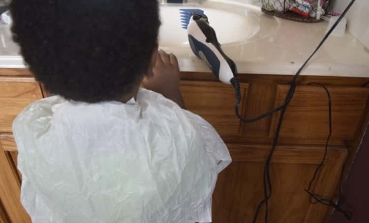 Amazing packing hack- a plastic bag used as a smock over a child to collect bits of hair 