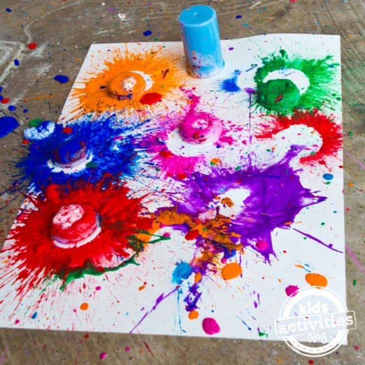 A photo of paint splashed onto a watercolor paper using paint bombs made from alka-seltzer tablets 