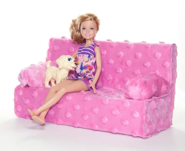 Barbie doll seated on couch made from tissue box