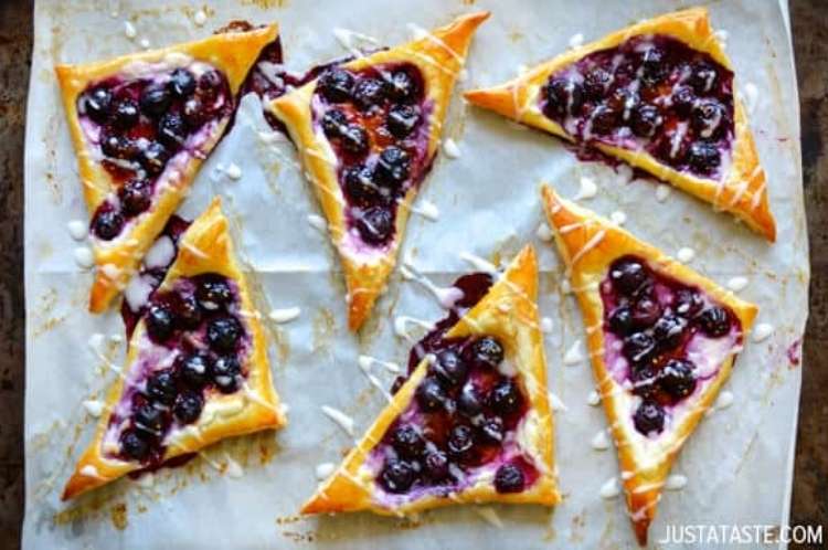 Blueberry and cream-cheese topped pastries drizzled with white glaze