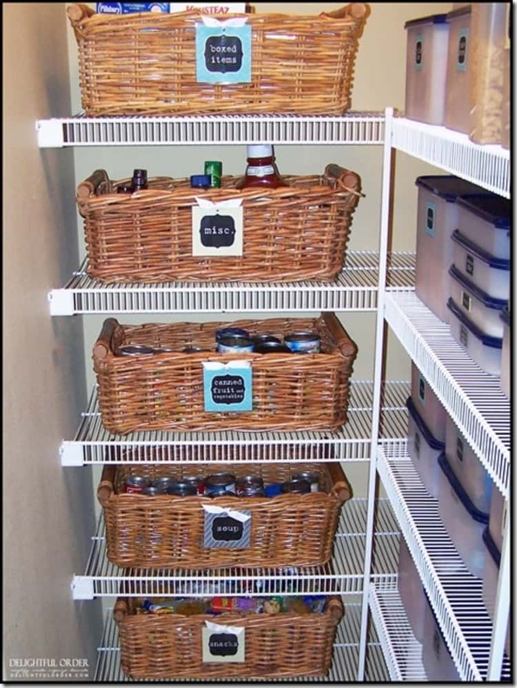 wicker baskets on pantry shelves with labels on the front and food stored inside