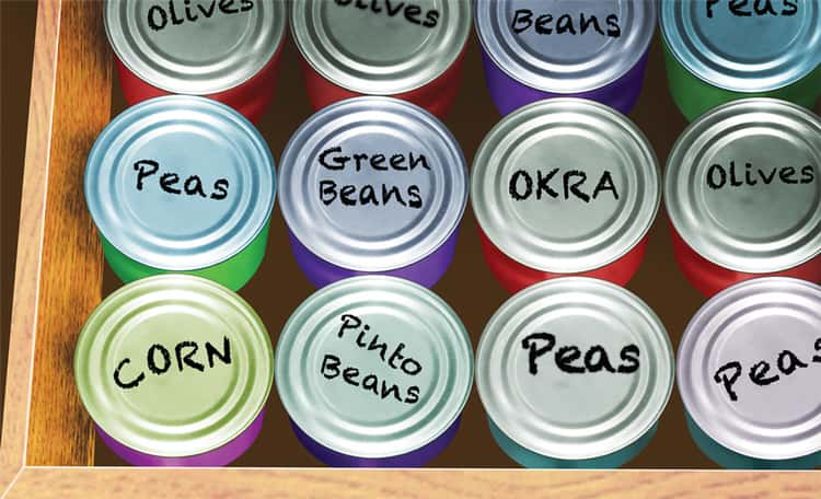 canned goods stored in a drawer with the names written on the top with a black marker