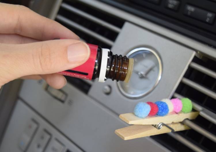 Genius essential oils tips and tricks - image of essential oil drops added to car vent diffuser