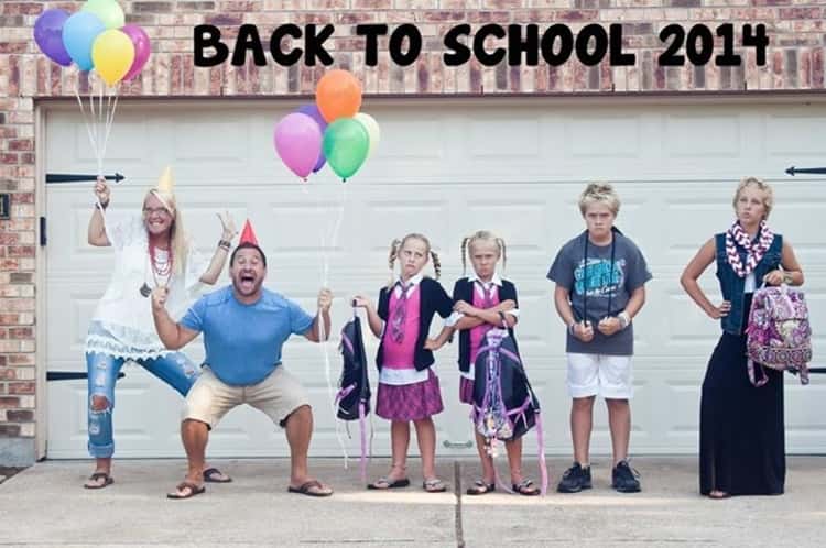 back to school photo ideas - 2 parents celebrate back to school while 4 kids stand there looking unhappy