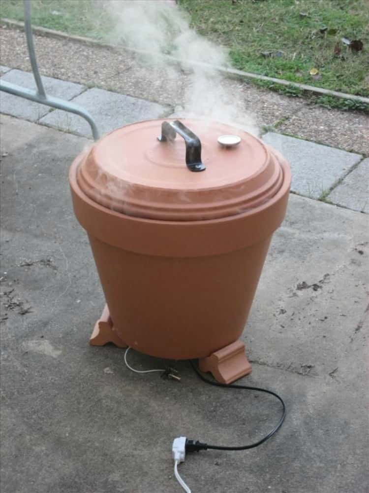 An outdoor smoker made with a clay pot and some DIY skills