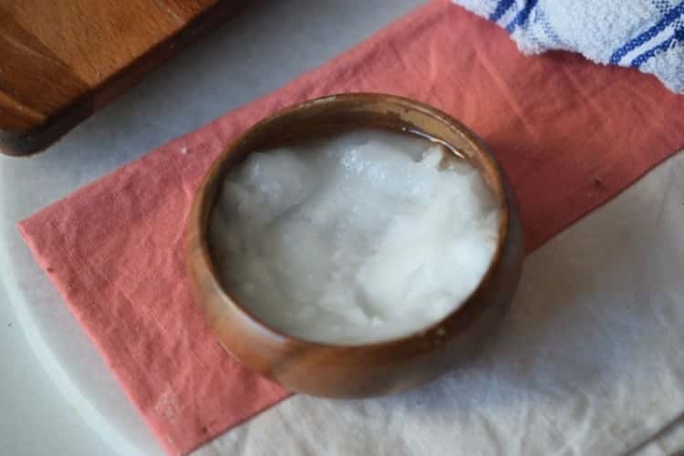 coconut oil in wood bowl on counter