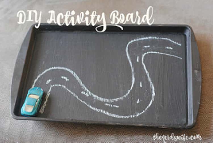 DIY activity board- this one has a road-track drawn on it and a toy car
