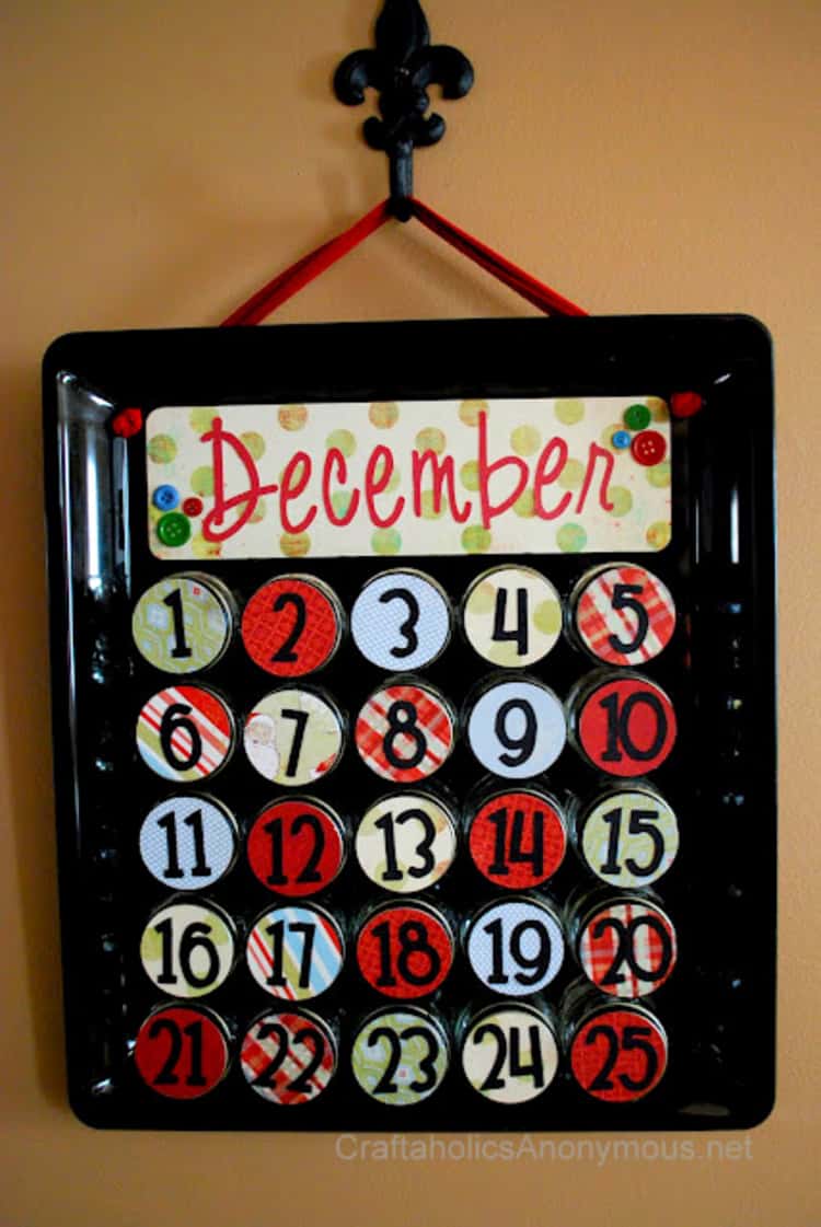 A colorful advent calendar made from a cookie sheet and baby food jars