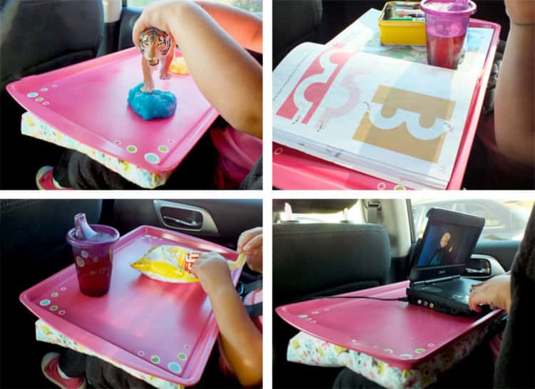 A cookie sheet used as a travel tray to place food and toys while in the car 