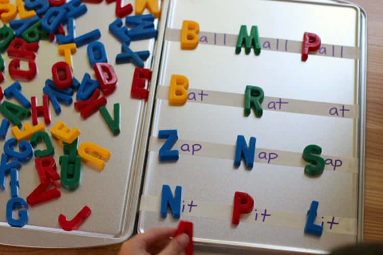 Cookie sheet used as a board for word-building activities