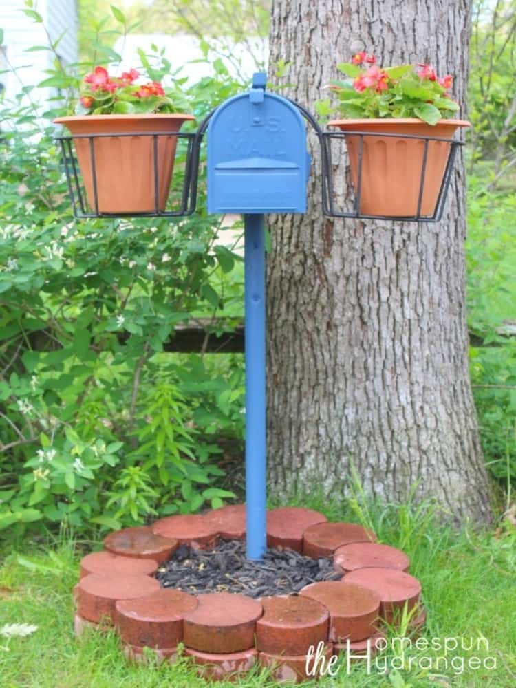 frugal mailbox makeovers using a plant holder and a flower pot on each side of the freshly painted mailbox