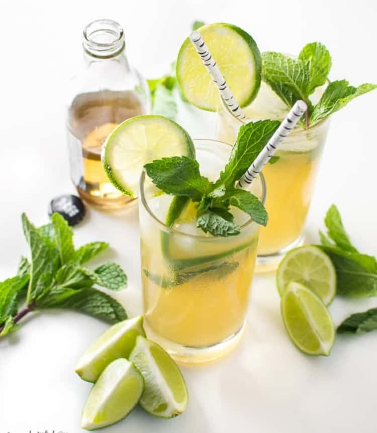 2 Ginger Beer Mojitos garnished with mint leaves and lemon slices