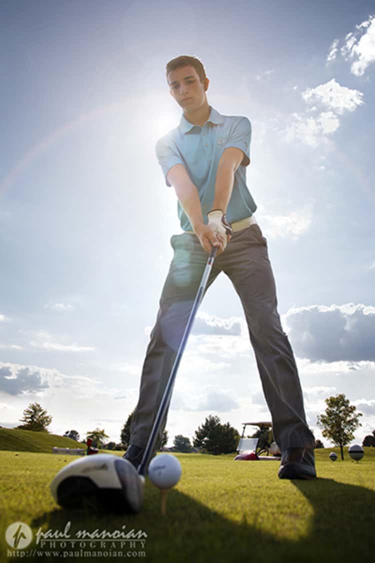 senior picture ideas for guys - guy seen getting ready to hit a golf ball 