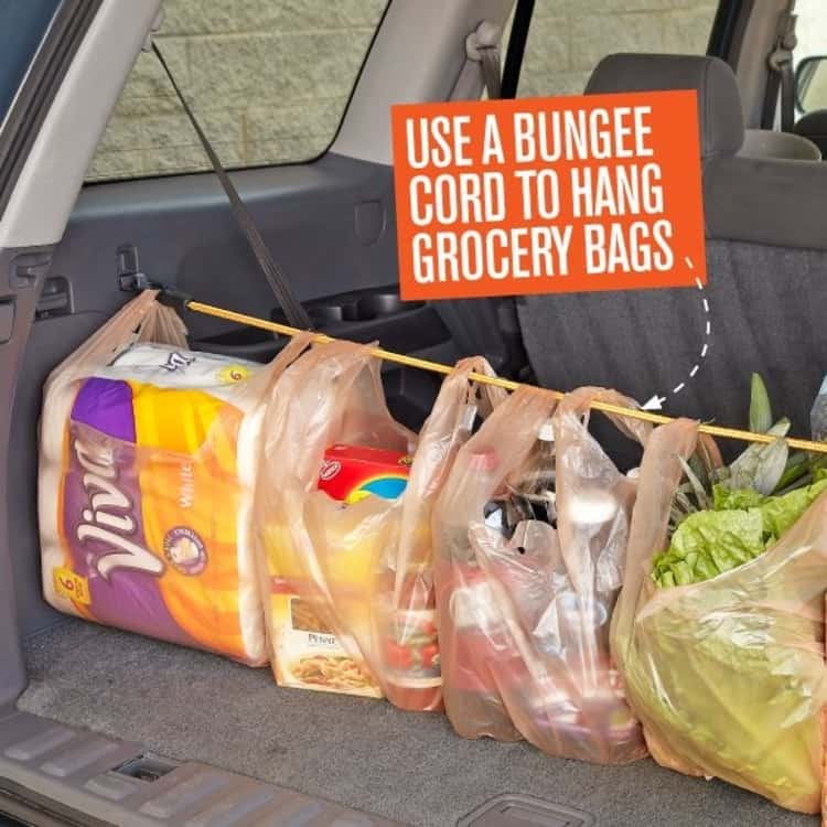 bungee cord uses - a bungee cord in use to hang grocery bags in the trunk