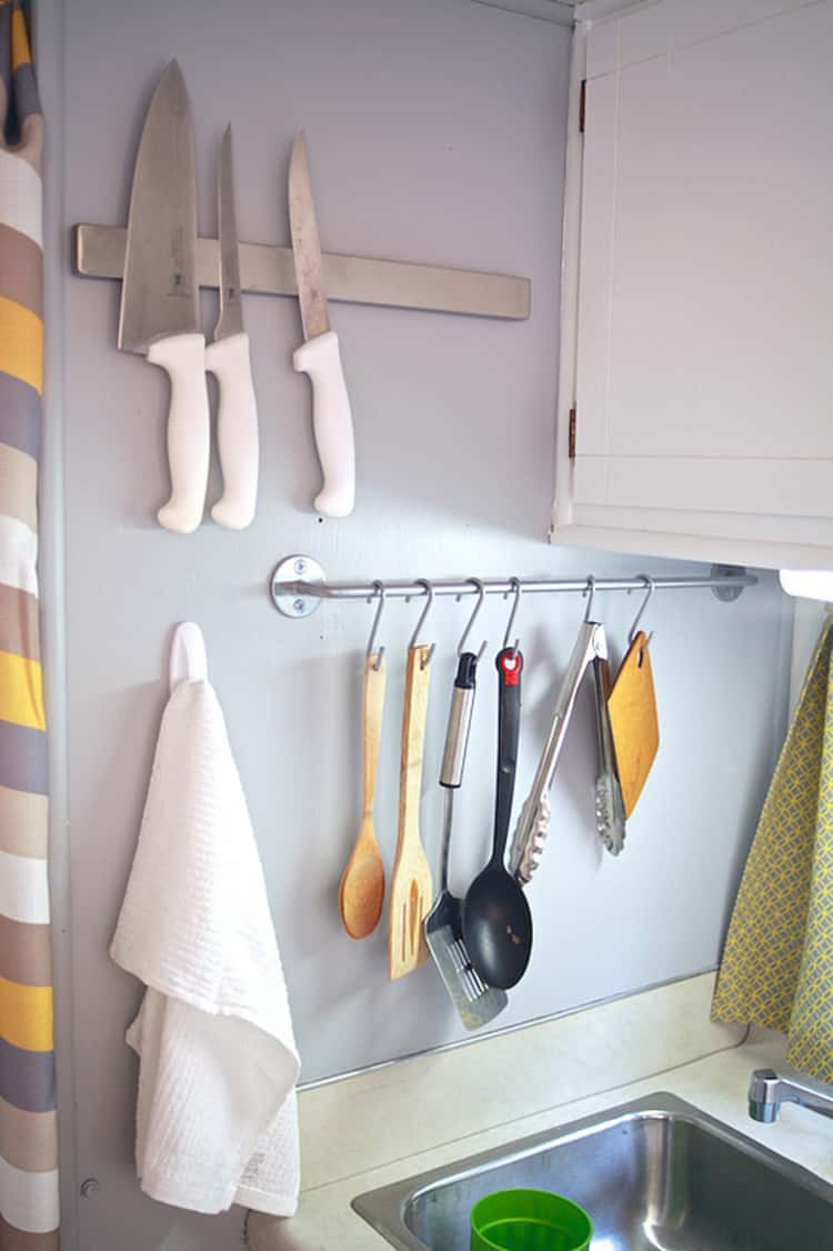 hanging utensils on shower hooks next to sink