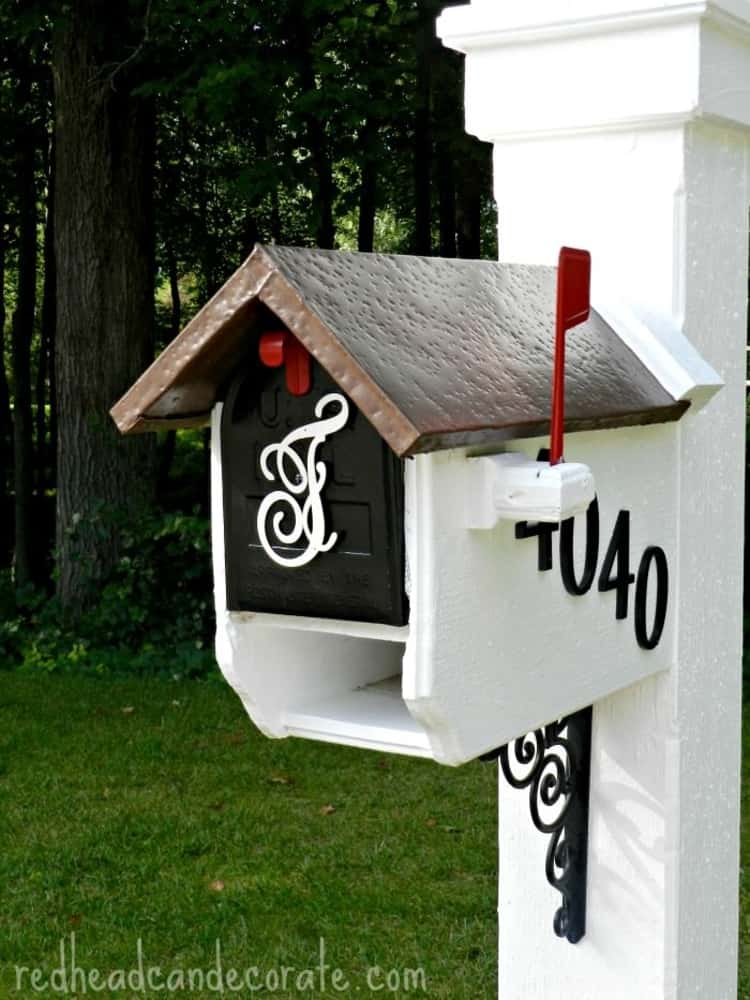 mailbox makeover - house-style mailbox painted in white and black with red accents