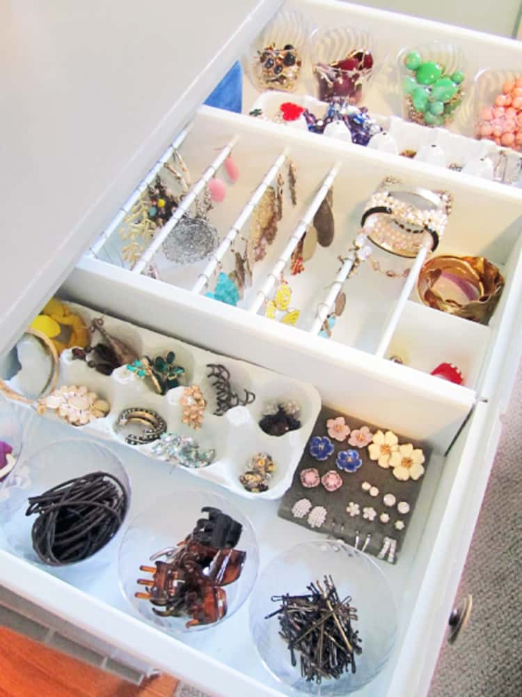 Egg carton in use as a jewelry organizer