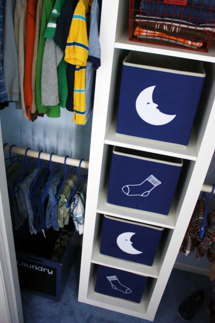 a young boy's closet with 2 clothing bins with a moon image to store pyjamas and two clothing bins with a sock image to store socks