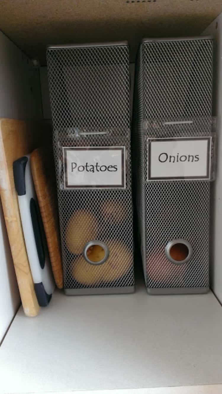 Organized pantry storage for potatoes and onions in magazine holders