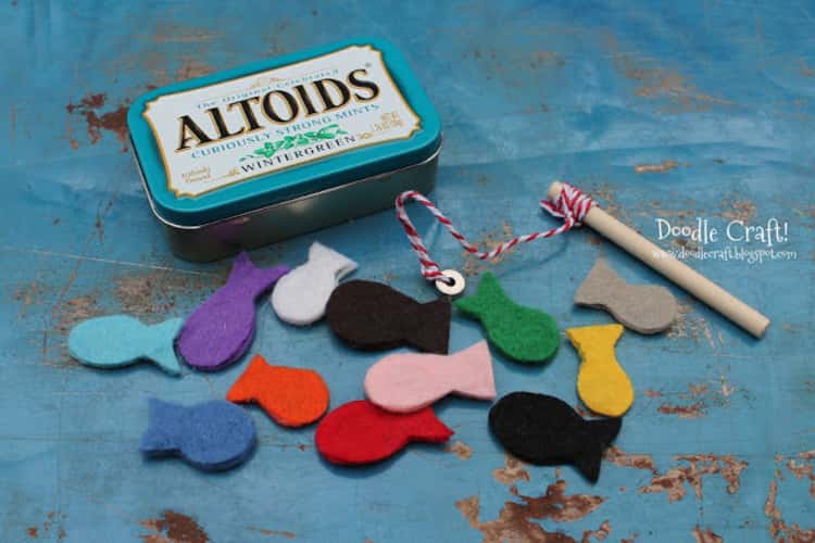altoids tin next to felt cut out fish and a wooden dowel with a sting attached