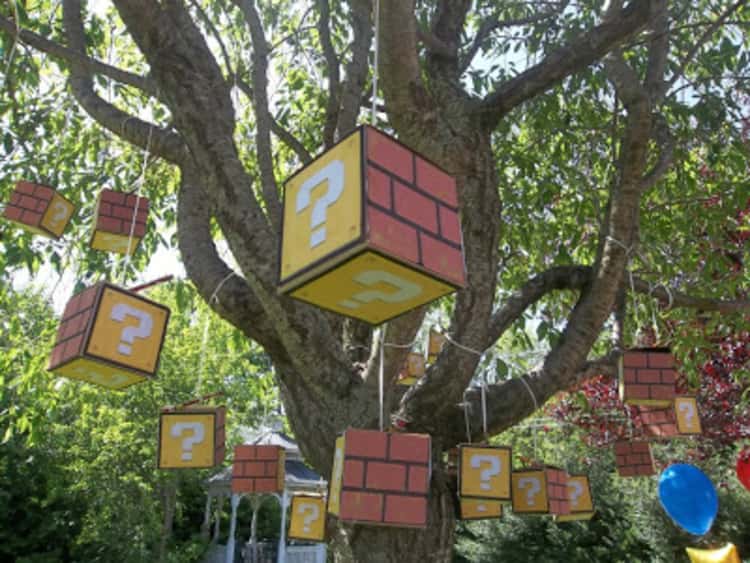 tissue box uses - Mario-themed boxes hung up in a tree as party decorations