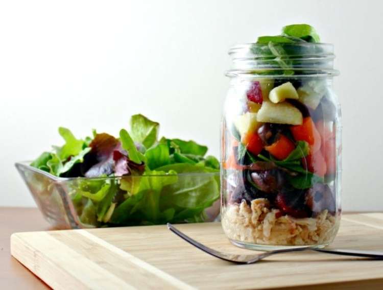 Salad in a square bowl and in a glass